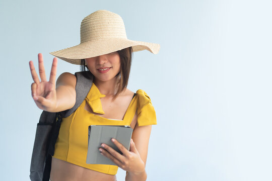 Anonymous Woman Traveler Holding Computer Tablet, Pointing Up Three Fingers, Number 3, Third Point Or Three Points Hand Gesture