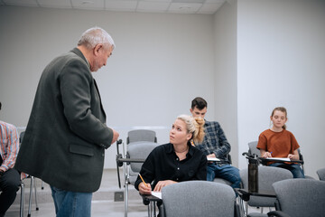 In a mathematics class at the university, an elderly professor approaches students during the lesson and asks questions on the topic to everyone