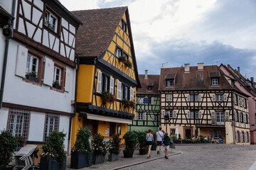 Colmar, Alsace, France, 4 July 2022: town capital of Alsatian wine, narrow picturesque street with...