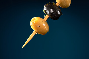 Finger food sticks with olives.
