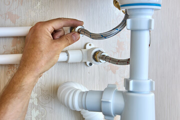 Braided plumbing hoses are used to install faucet in bathroom and connect to home water supply...