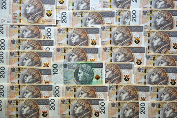 dużo polskich banknotów 200 złotowych i jeden banknot 100 złotowy 