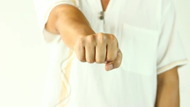 Man is clenching fist, in studio Chiangmai Thailand.