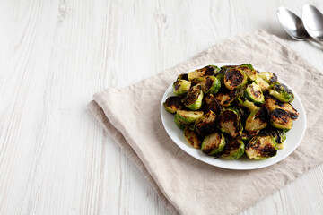 Homemade Roasted Brussel Sprouts on a Plate, side view. Copy space.