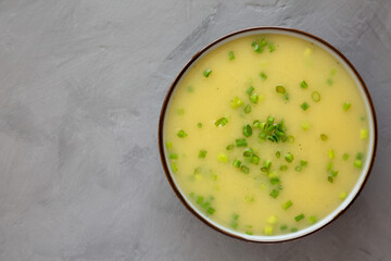 Homemade Potato Leek Soup in a Bowl on a gray background, top view. Flat lay, overhead, from above. Copy space.