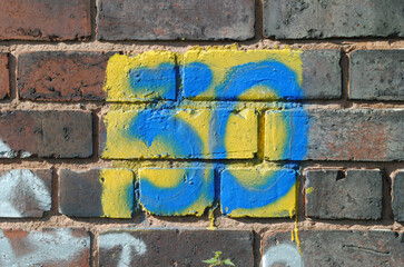 Number '30' Painted on Old Textured Brick Wall