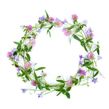 Beautiful wreath with colorful flowers isolated on a white background. Midsummer celebration concept, summer decoration. Top view.