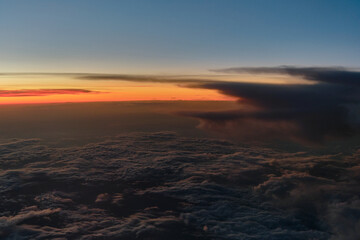 clouds photographed from the window curtain of an airplane