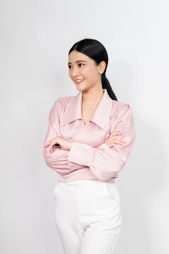 Portrait photo of a young beautiful classy and elegant asian businesswoman in smart casual pink business shirt with friendly nice smile and pose