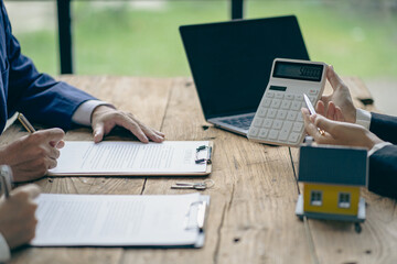 A sales representative is discussing the details before the customer agrees to sign a contract. by explaining the details and terms and conditions of the rental real estate concept
