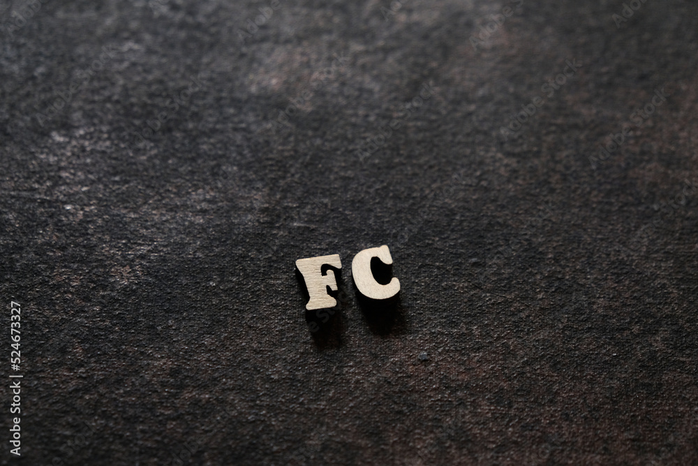 Fototapete the letters f and c above the dark field. initials fc