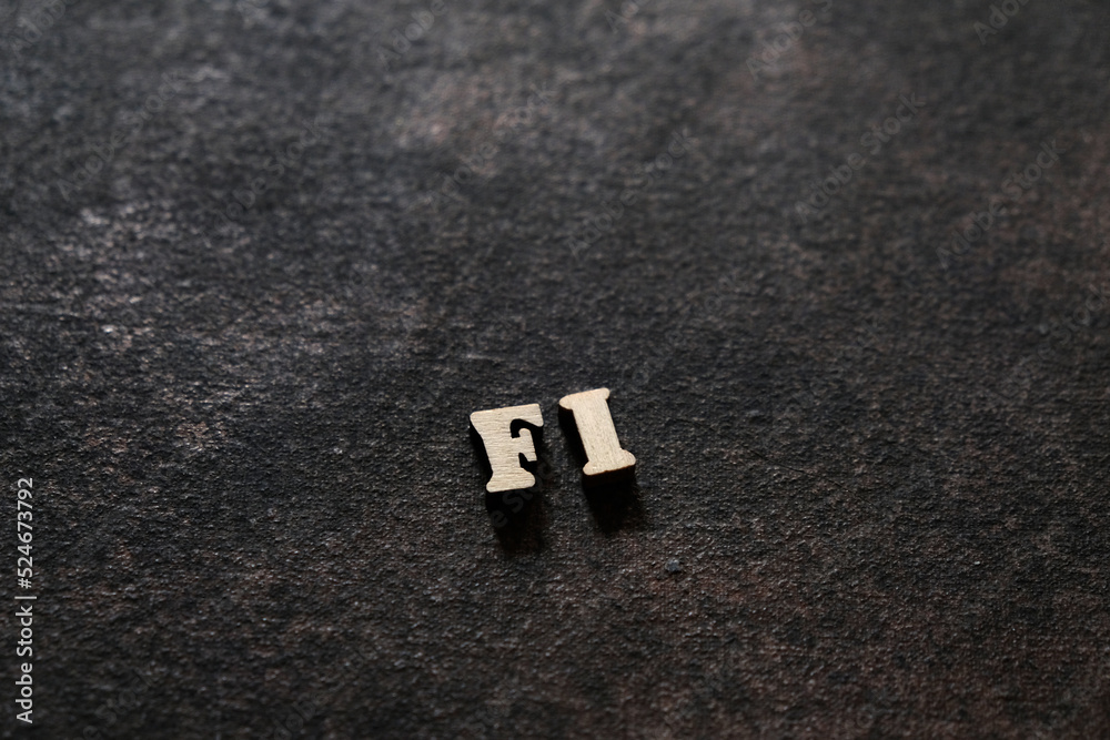 Fototapete the letters f and i above the dark field. initials fi