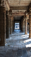 Beautiful stone corridor with stellar sculptures in an ancient Kumbakonam temple, Tamil Nadu, India