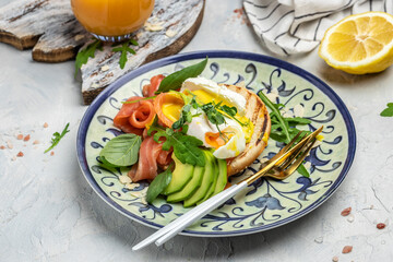 Fototapeta na wymiar Healthy nutritious paleo keto breakfast diet avocado and Poached Egg, cheese, salmon and fresh salad, fresh juice, Keto breakfast or lunch. place for text, top view