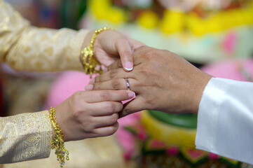 Wearing a wedding ring Thai Wedding Ceremony,The groom is wearing a wedding ring for the bride