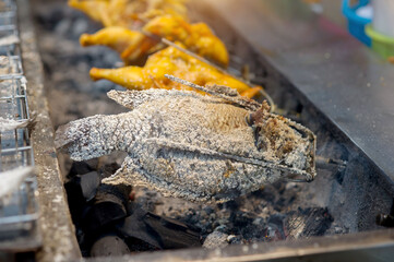 Grilled chicken and fish on the grill rack