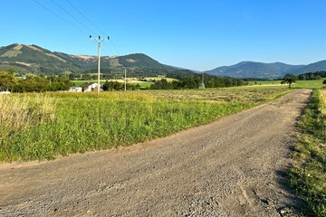 Fototapeta na wymiar dirt road in the countryside with hills