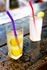Cocktail with lime in tumbler glass