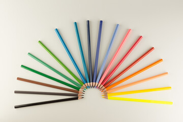 set of colored pencils lined by an arc