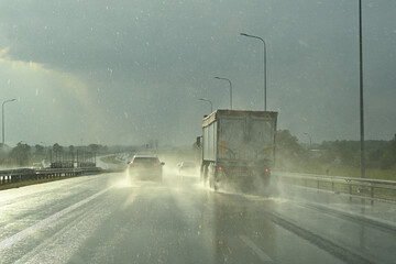 Cars on the highway on a rainy day. Lots of water drops. Concept of safe driving