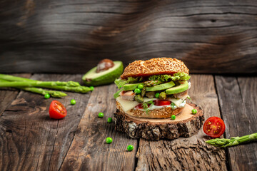 Delicious burgers with chicken fillet, asparagus, avocado, tomatoes, peas, cheese and tartar sauce. fast food and junk food concept