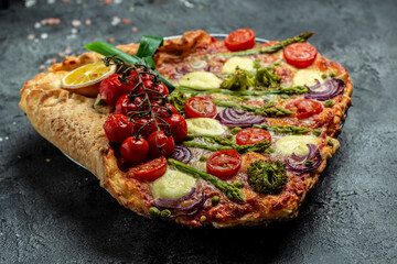 Pie with fresh asparagus, sweet peas, mozzarella and cherry tomatoes. Vegan food recipe background