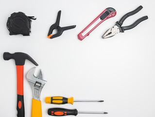 Top view of construction tools and tools highlighted on a white background with a space in the center
