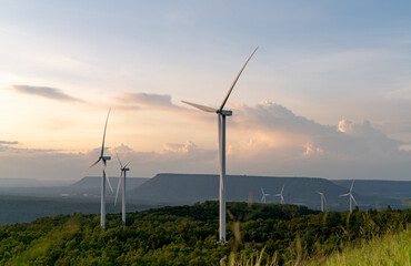 Wind energy. Wind power. Sustainable, renewable energy. Wind turbines generate electricity. Windmill farm on mountain with sunset sky. Green technology. Renewable resource. Sustainable development.