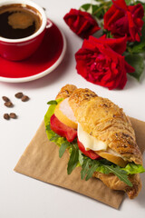 Crispy croissant with ham on parchment