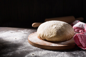 Fototapeta na wymiar Homemade Holemeal Dough for Bread on Brown Wooden Table with flour