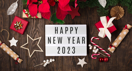 Happy New Year text on white Lightbox with red flower poinsettia and Christmas decorations