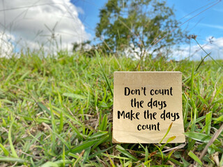 Don't count the days make the days count text on paper with nature background. Inspirational and Motivational Concept.