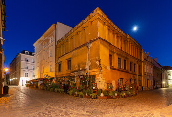 Krakow. Old houses in night illumination at dawn.