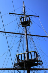 Mast of the ship on the background of blue sky