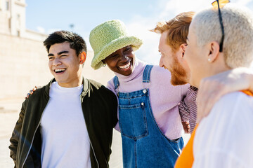 Happy multi ethnic group of young friends having fun together outdoors - Diverse men and women...