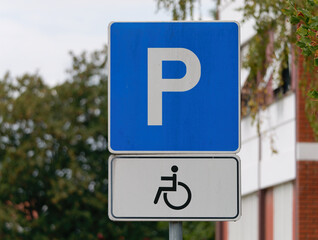 Close-up shot of a handicapped parking sign attached on a  metal pole 