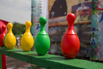 Red , yellow  and green colored plastic skittles stand in row