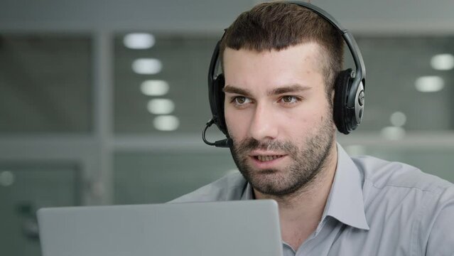 Millennial confident manager talking to employees negotiating using headset on online conference in office professional call center operator consulting client speaking to customer uses remote web chat