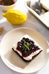 Homemade creamy cheese pie with juicy blueberry sauce and fresh blueberries. 