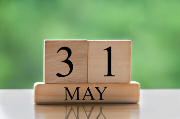 May 31 calendar date text on wooden blocks with blurred nature background. Copy space and calendar concept