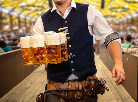 Oktoberfest, Munich. Waiter serve beer, close up. Octoberfest German festival.