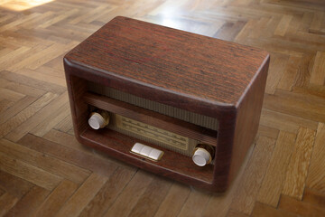 Nostalgia concept. Retro radio on wooden floor background. Overhead view. 3d render