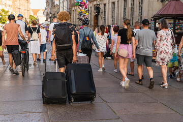 Lots of tourists on the main street in the historical center of Gdansk walking on a sunny summer...