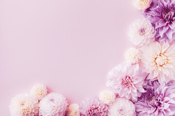 Beautiful dahlia flowers on pastel table with copy space for your text top view and flat style. Greeting card for birthday or mother day.