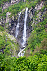 Obraz na płótnie Canvas Polikarya Waterfall, located on the slope of Mount Aibga, in Krasnaya Polyana, Sochi. The height of the waterfall is 70 meters 