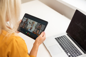 Smiling millennial woman using modern gadget, chat on tablet device, technology concept