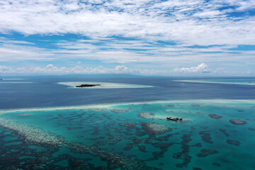 Naklejka na ściany i meble Drone point of view of turquoise colored ocean and reef in Semporna Sabah Borneo Malaysia