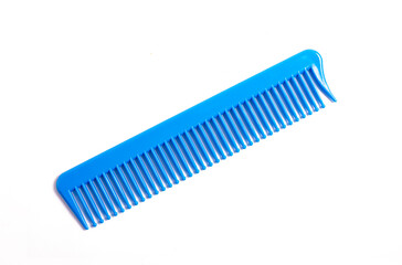 Blue Plastic Comb Insaled on White. View from above.