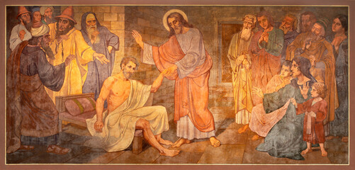 BERN, SWITZERLAND - JUNY 27, 2022: The fresco of Christ at the healing in the church Dreifaltigkeitskirche by August Müller (1923). - obrazy, fototapety, plakaty