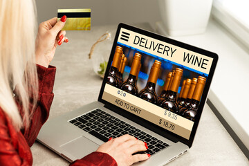 Buying wines online, home delivery concepts. screen laptop computer on table with wine bottle